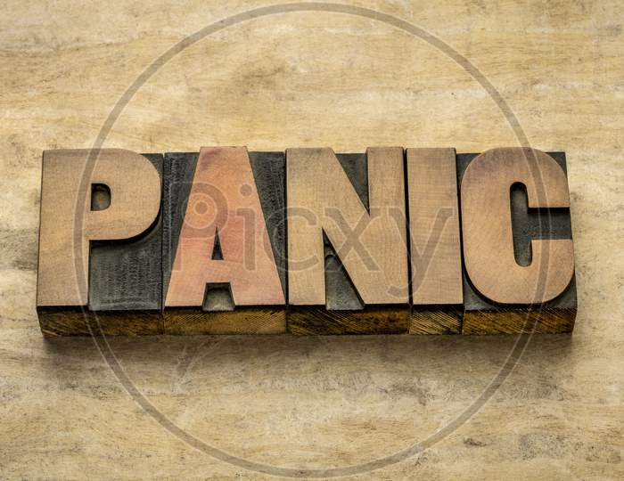 Panic Word Abstract In Vintage Letterpress Wood Type Against Grunge Handmade Paper, Sudden Uncontrollable Fear Or Anxiety