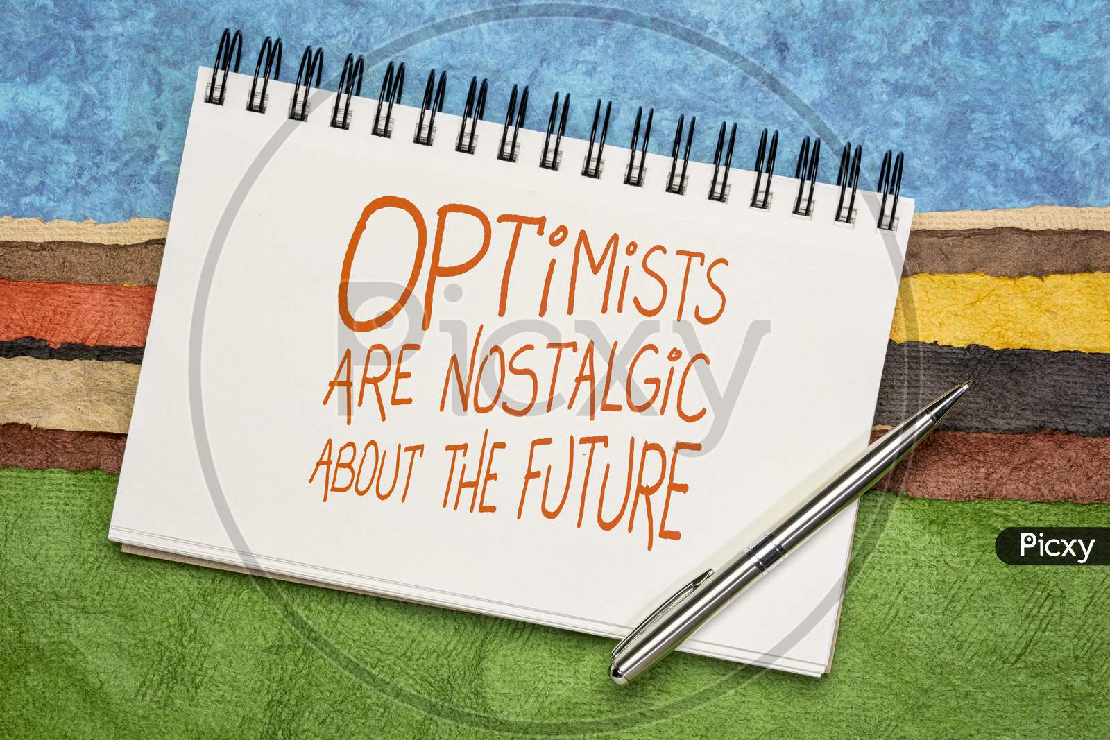 Optimists Are Nostalgic About The Future  Inspirational Quote - Handwriting In A Sketchbook Against Colorful Abstract Landscape.  Positivity Concept.
