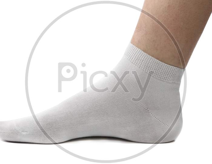 Man Foot With Sock On. Isolated On A White Background.