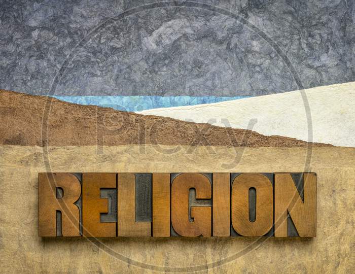 Religion Word In Vintage Letterpress Wood Type Against Abstract Paper Landscape, Spirituality Concept