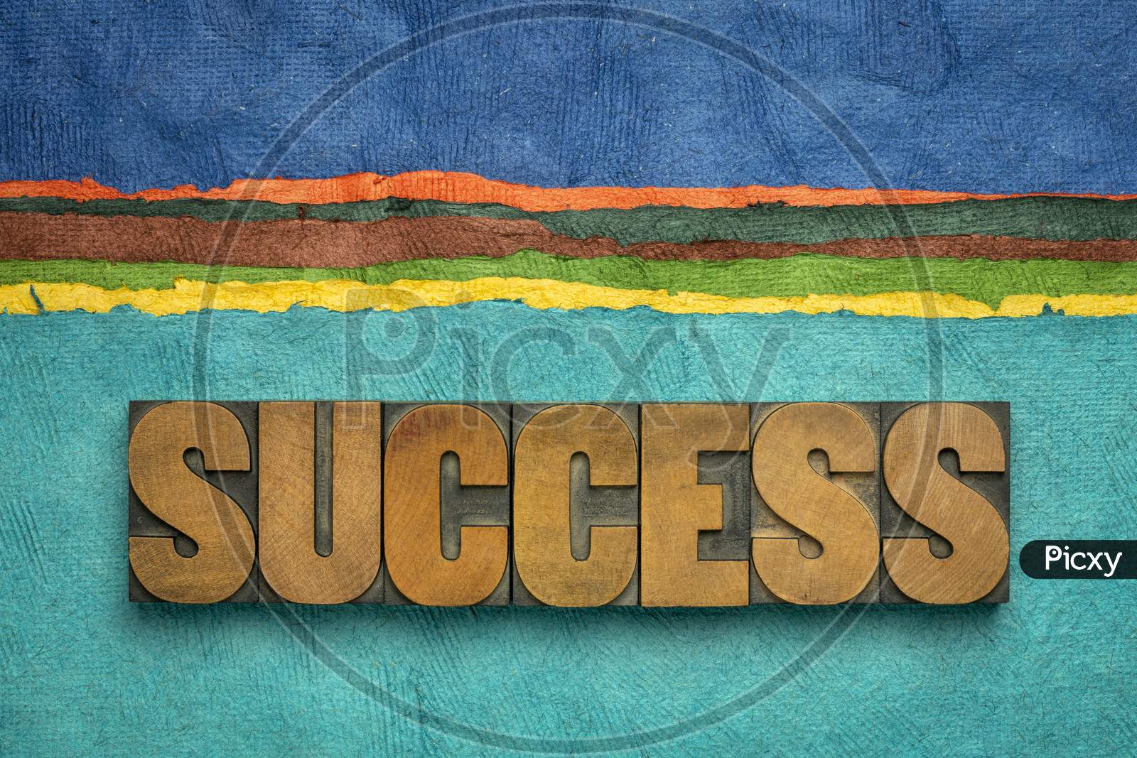 Success Word Abstract In Vintage Letterpress Wood Type Against Colorful Abstract Paper Landscape