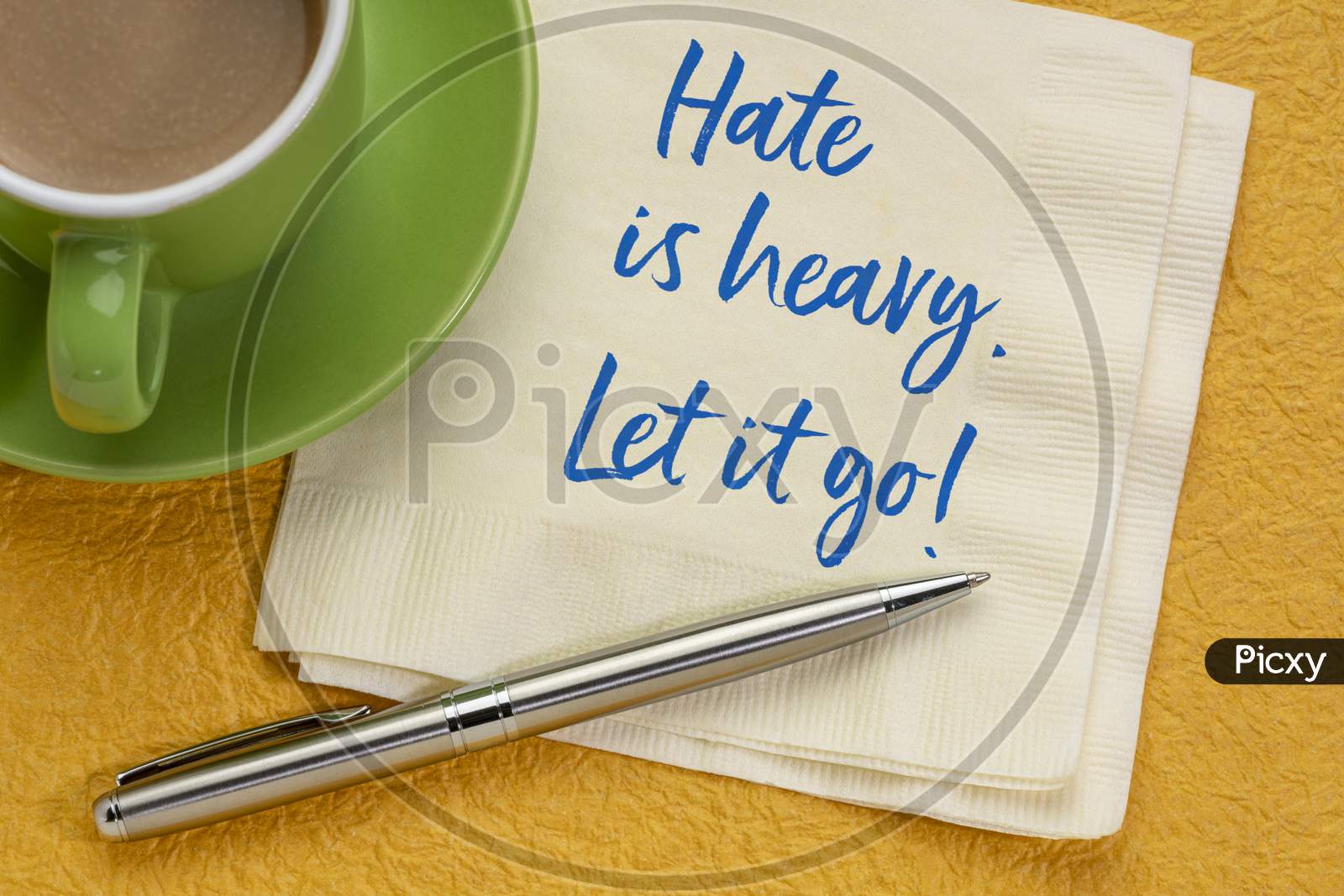 Hate Is Heavy. Let It Go! Inspirational Handwriting On A Napkin With Coffee. Stop Hating Concept.