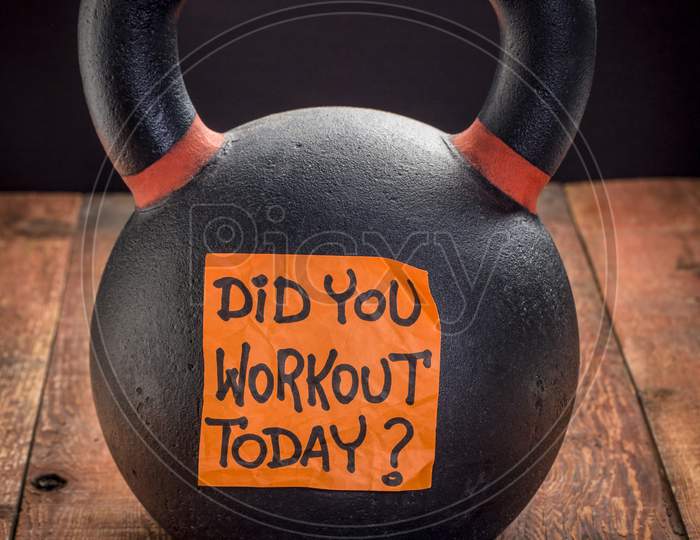 Did You Workout Today?  Reminder Note On A Heavy Iron Kettlebell Against A Rustic Wood Background - Exercise, Weight Training And Fitness Concept