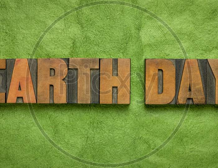 Earth Day - Annual Event Celebrated On April 22 To Demonstrate Support For Environmental Protection, Word Abstract In Letterpress Wood Type Against Green Handmade Paper