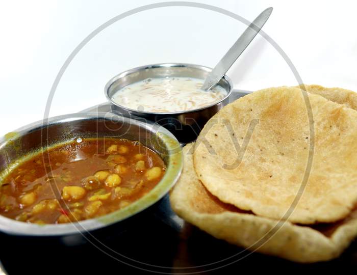 Indian Dish Spicy Chick Peas Curry Also Known As Chola/Chana Masala Or Commonly Chole, Served Served With Fried Puri