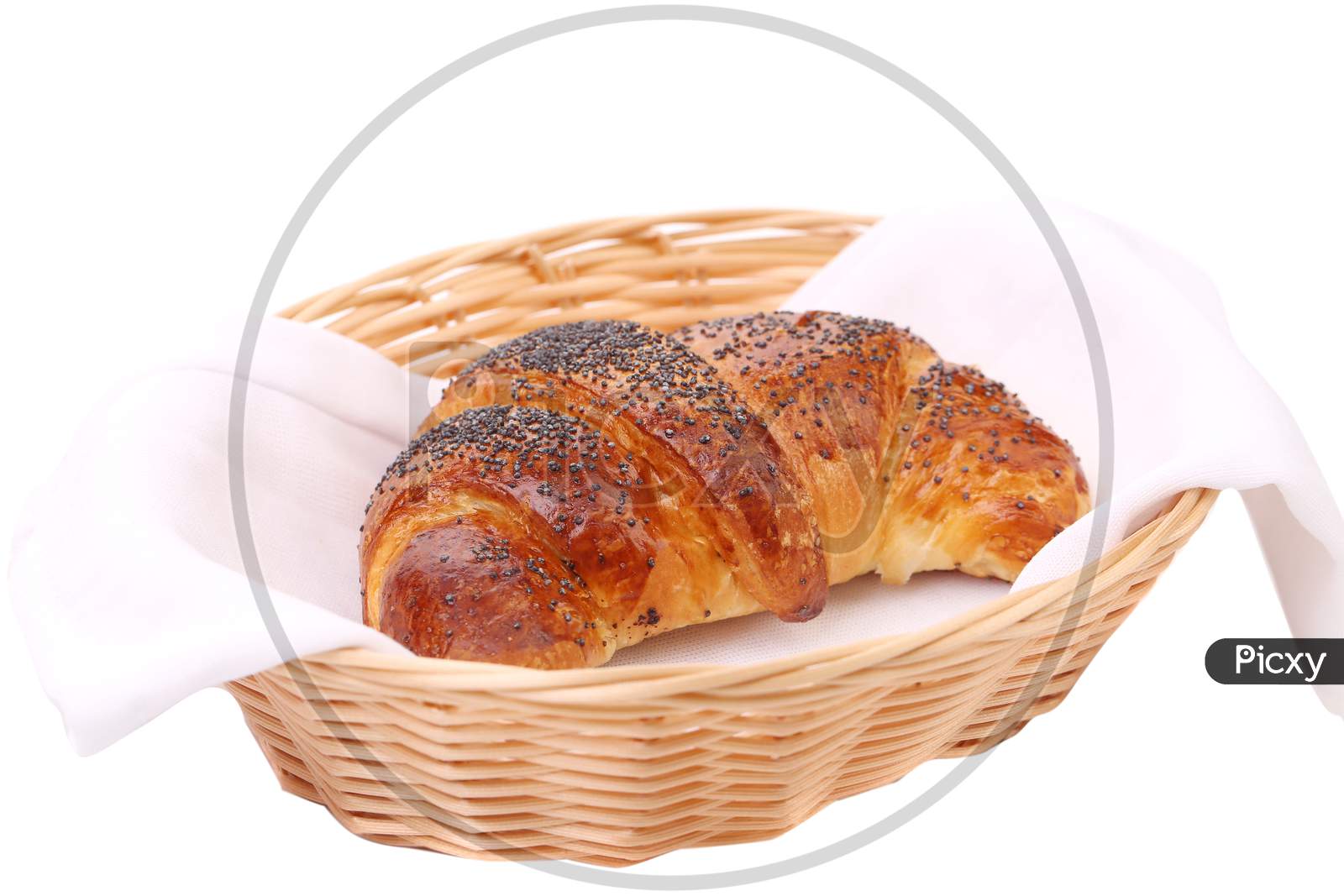 Image Of Croissant With Poppy In A Basket. Isolated On A White Background.