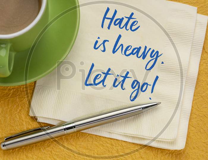 Hate Is Heavy. Let It Go! Inspirational Handwriting On A Napkin With Coffee. Stop Hating Concept.