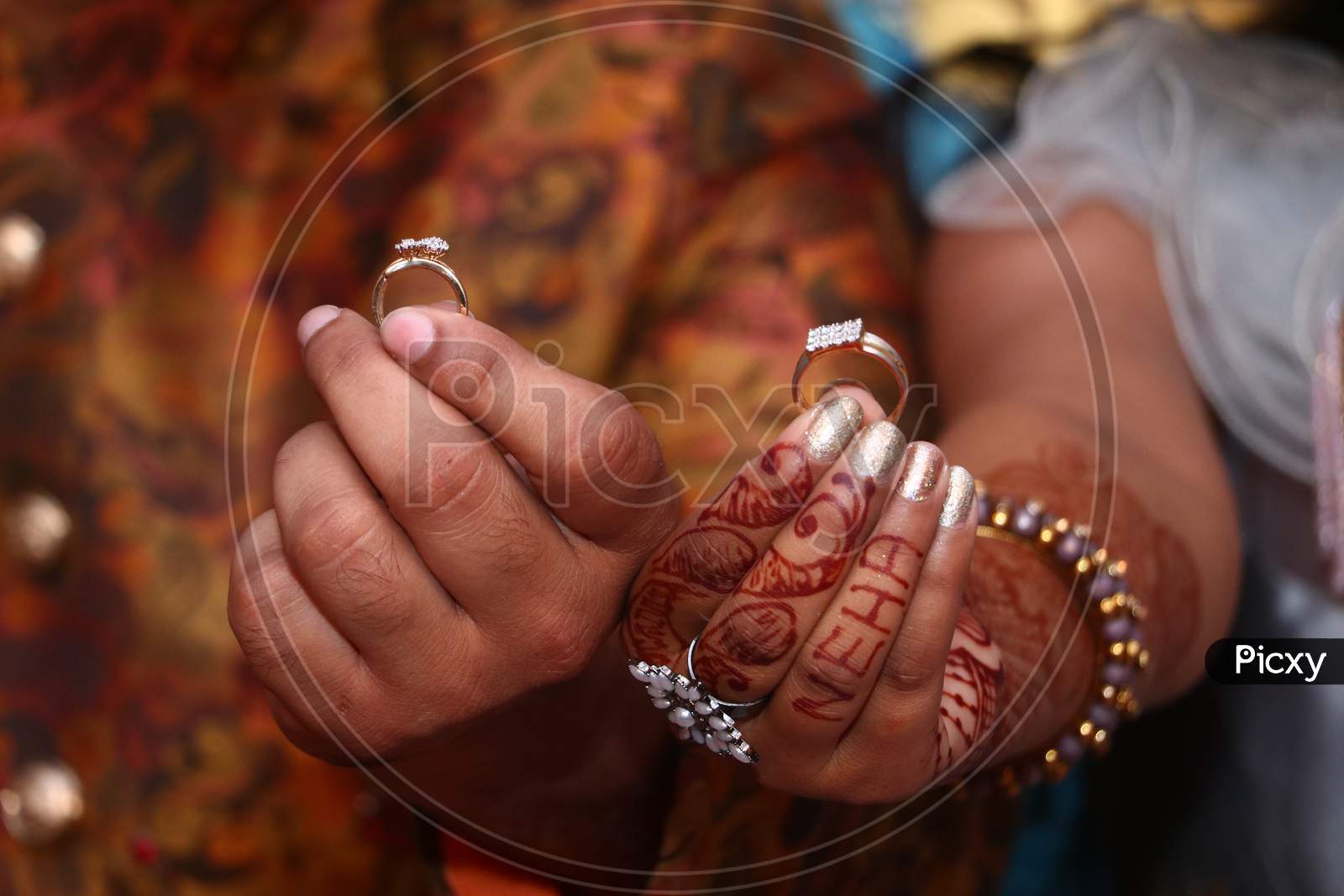 Wedding couple showing rings in ring Ceremony day