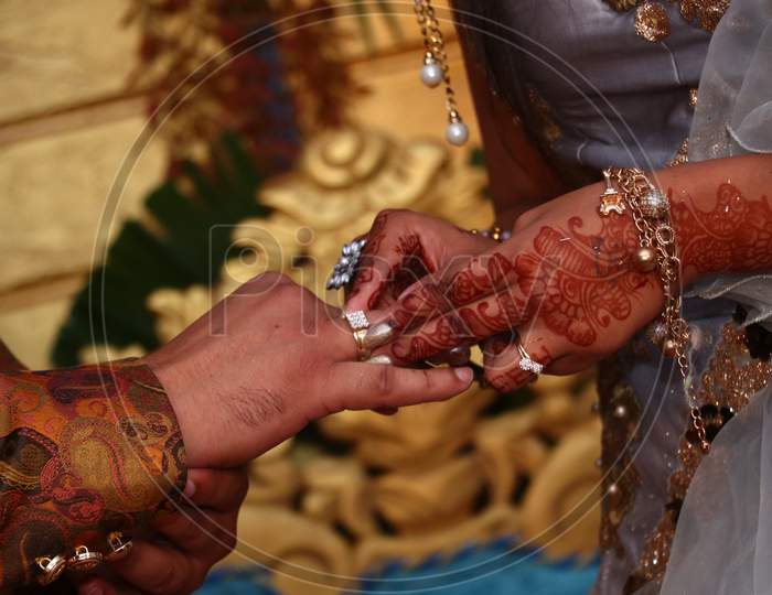 Wedding couple wearing rings to each other in ring Ceremony