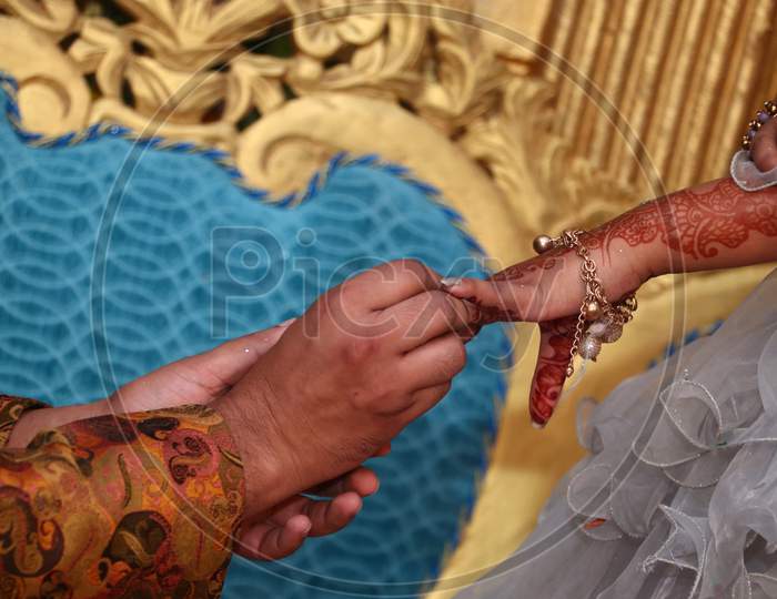 Wedding couple wearing rings to each other in ring Ceremony