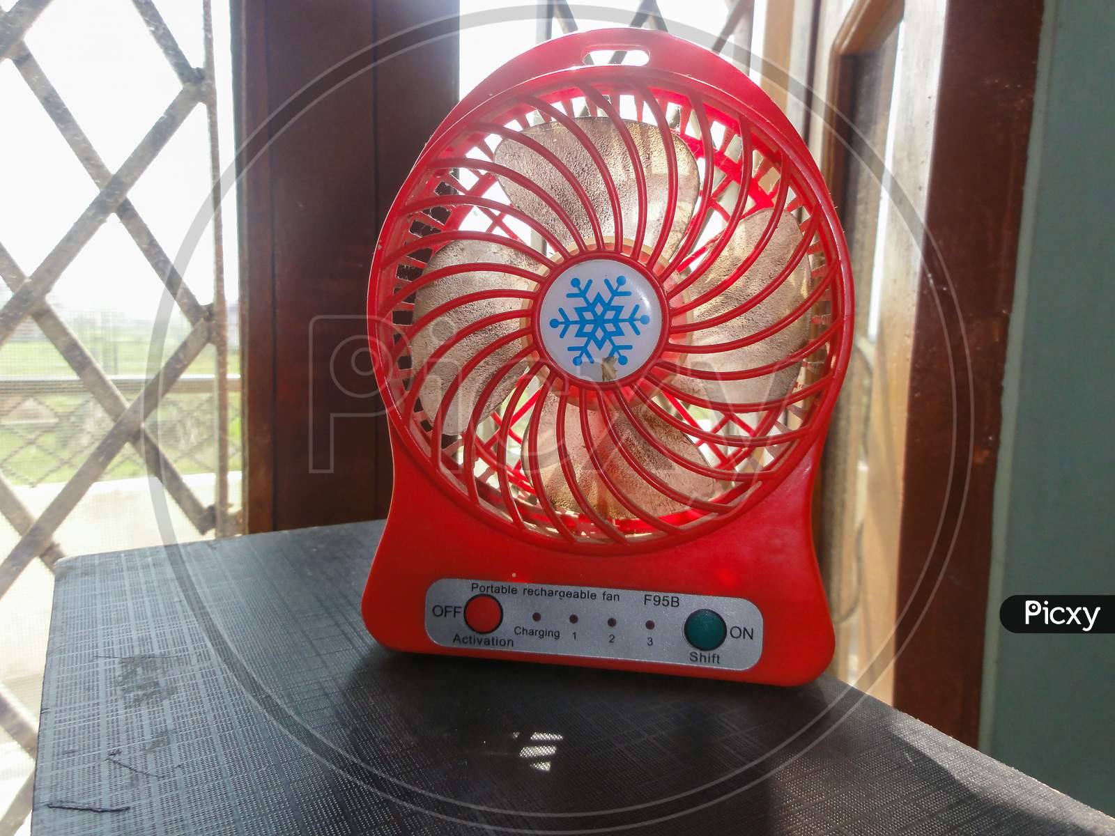 A Small Hand Fan At Home On The Table