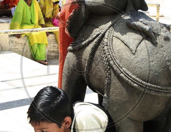 Passing under the elephant in Narmada mandir at Amarkantak, madhya Pradesh