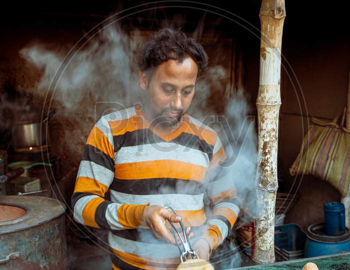 A Tea Vendor Making Tandoori Chai at a Tea Stall