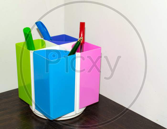 Pen stand in corner with four pens