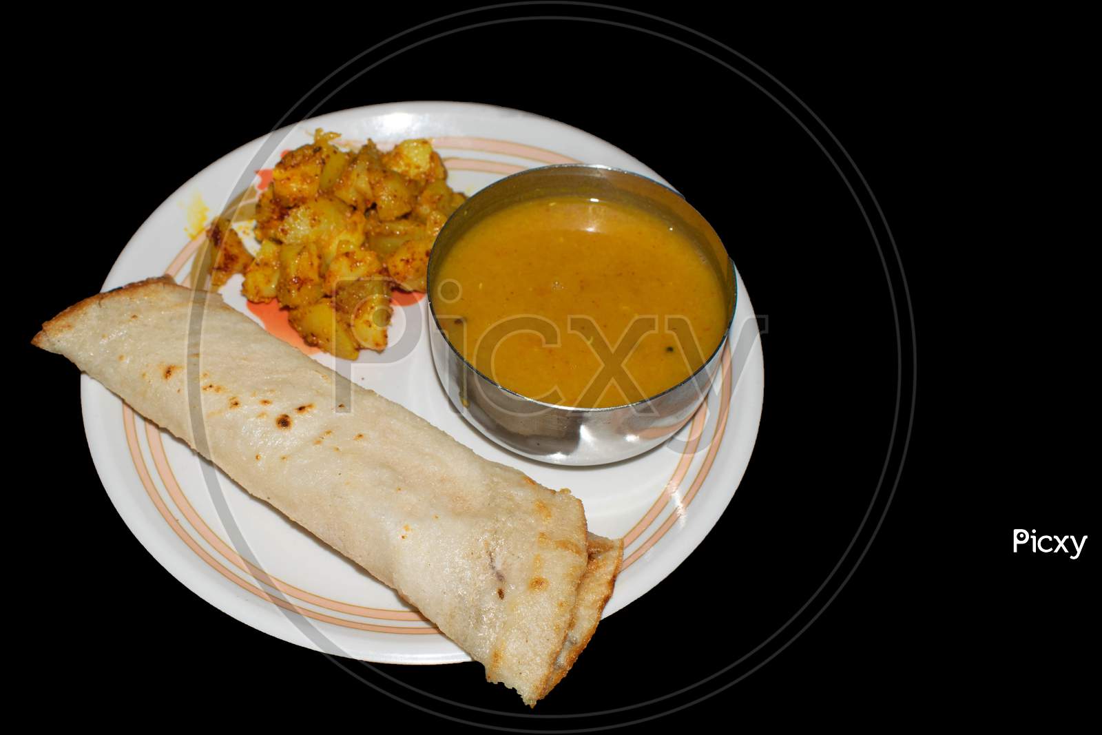 Masala dhosa in plate with dal in bowl