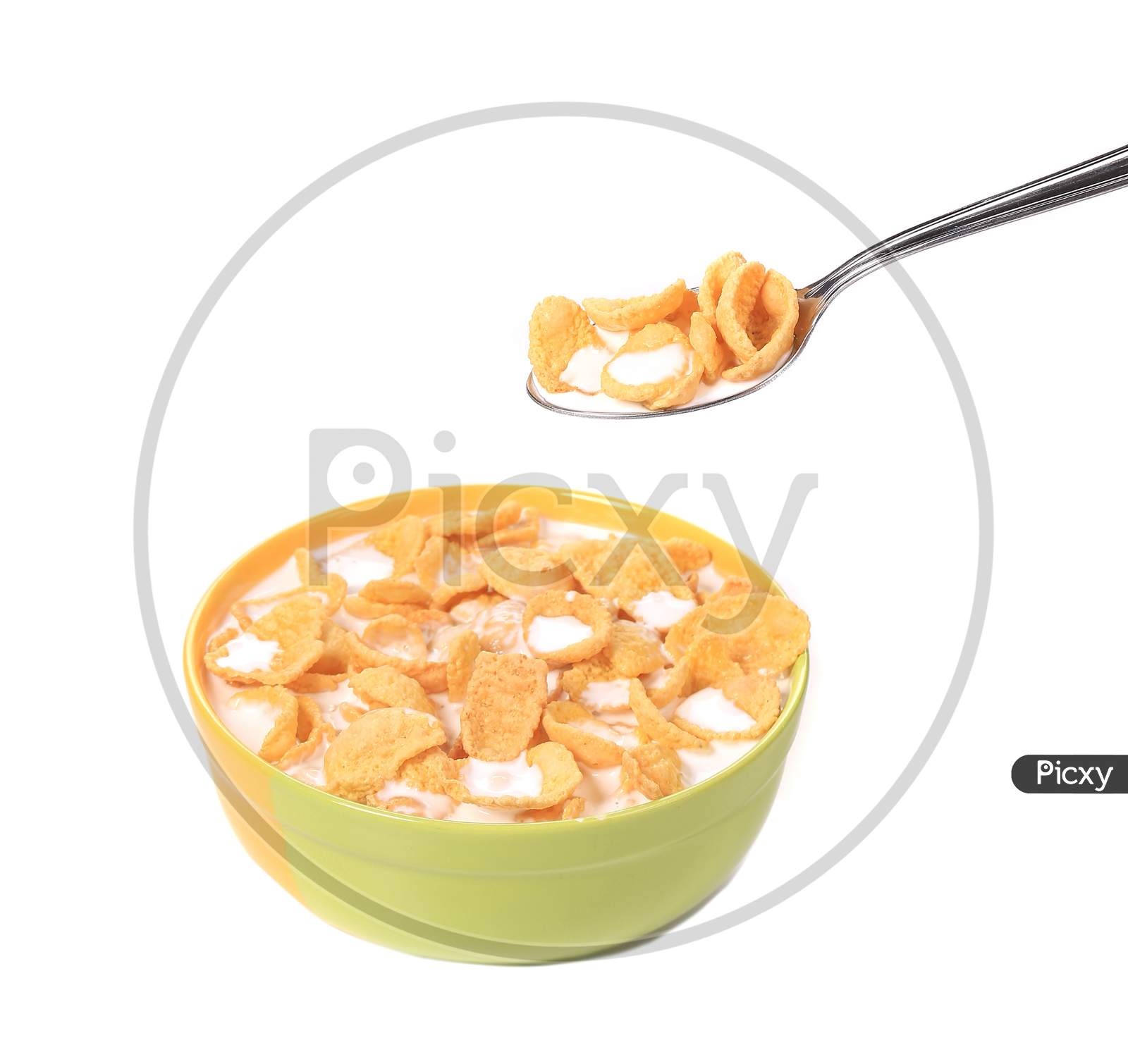 Bowl Of Sugar-Coated Corn Flakes With Milk And Spoon.