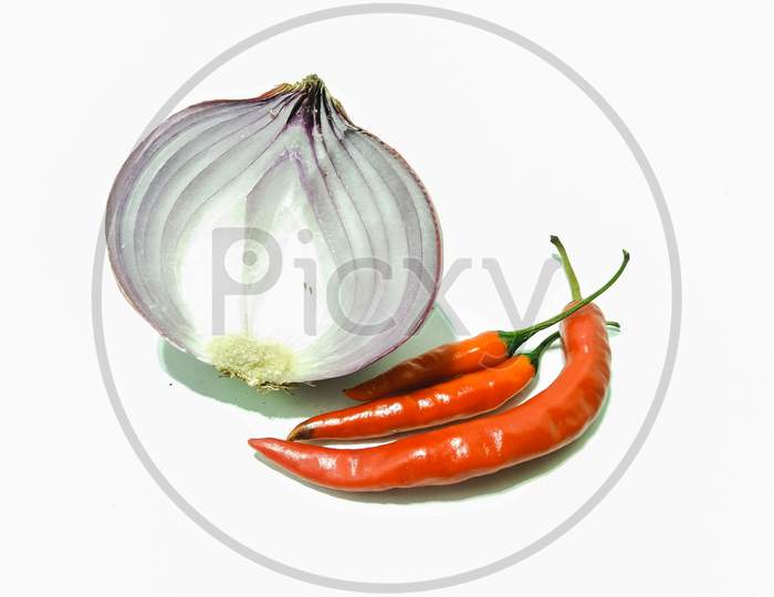 A picture of onions with red chilies