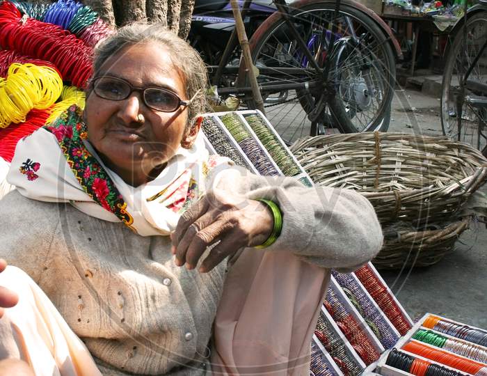Elderly woman selling bangles at street of Jaipur, rajasthan