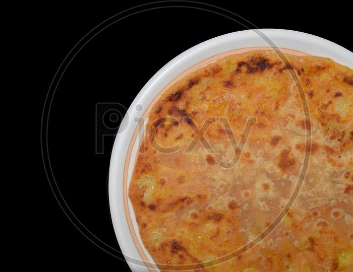Aloo parantha in plate with black background top view