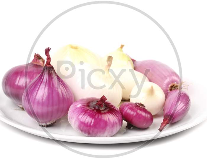 Wiew Of Different Onions On A Plate.  Isolated On White Background