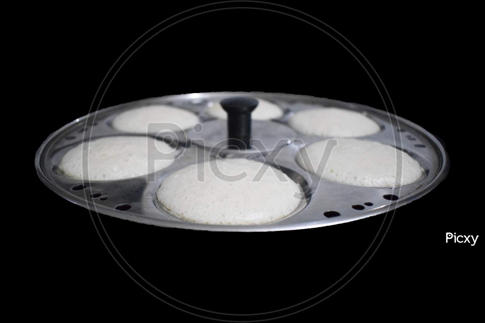 Idli in plate with black background front view south indian dish