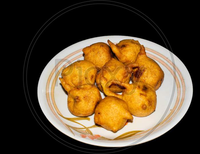Batata vada in plate with black background