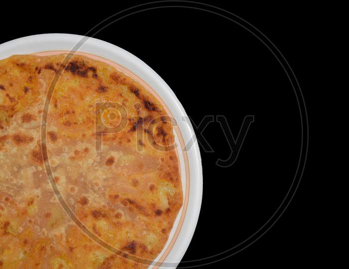 Aloo parantha in plate with black background top view