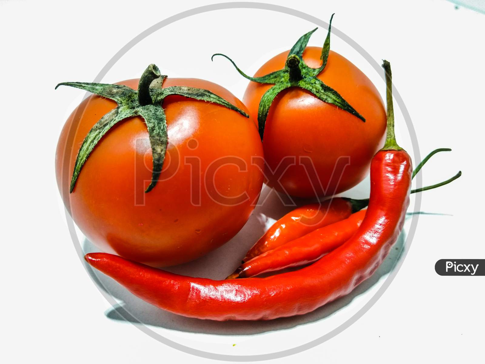 A picture of fresh tomato with red chili