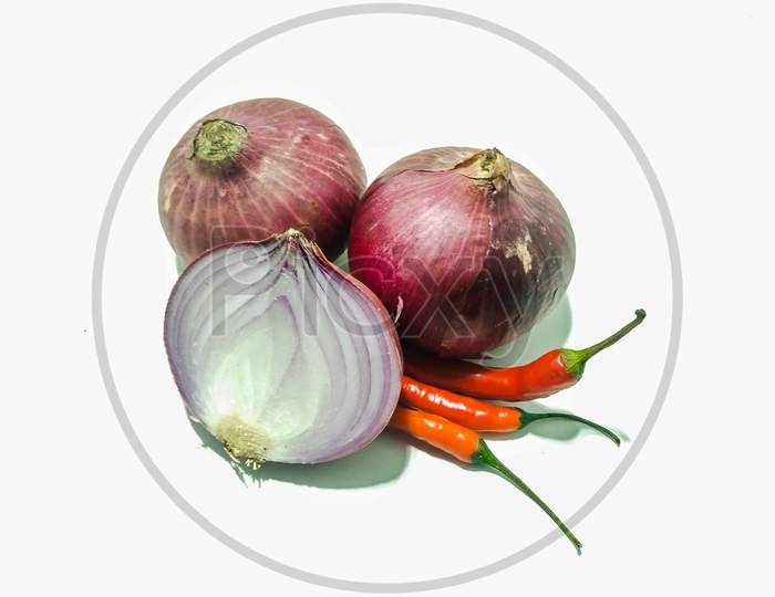 A picture of onions with red chilies