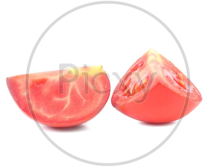 Two Sedments Of Fresh Tomato.  Isolated On White Background