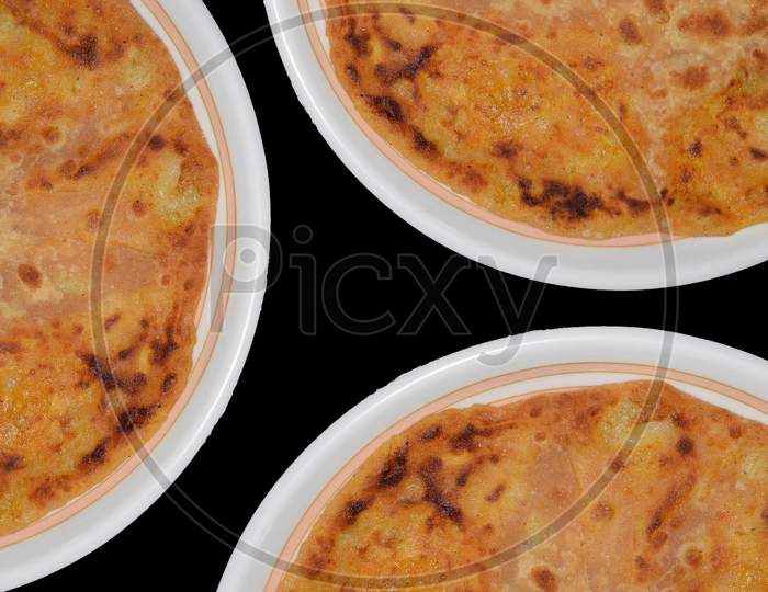 Aloo parantha indian breakfast and dinner top view with three plates