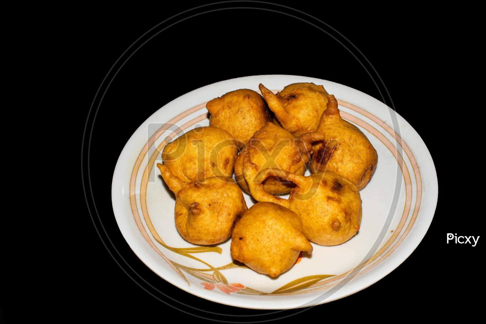 Batata vada in plate with black background
