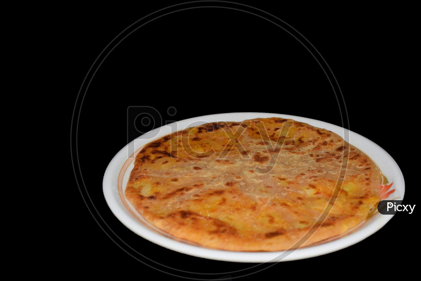 Aloo parantha in plate with black background front view
