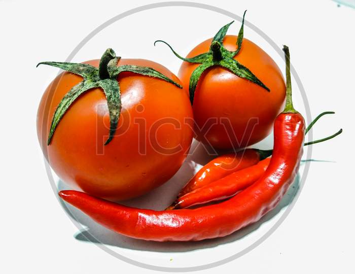 A picture of fresh tomato with red chili