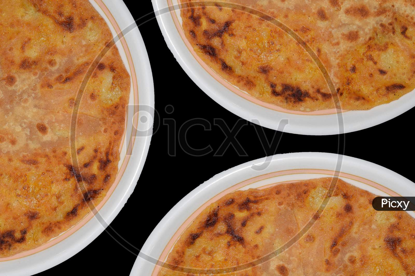 Aloo parantha indian breakfast and dinner top view with three plates
