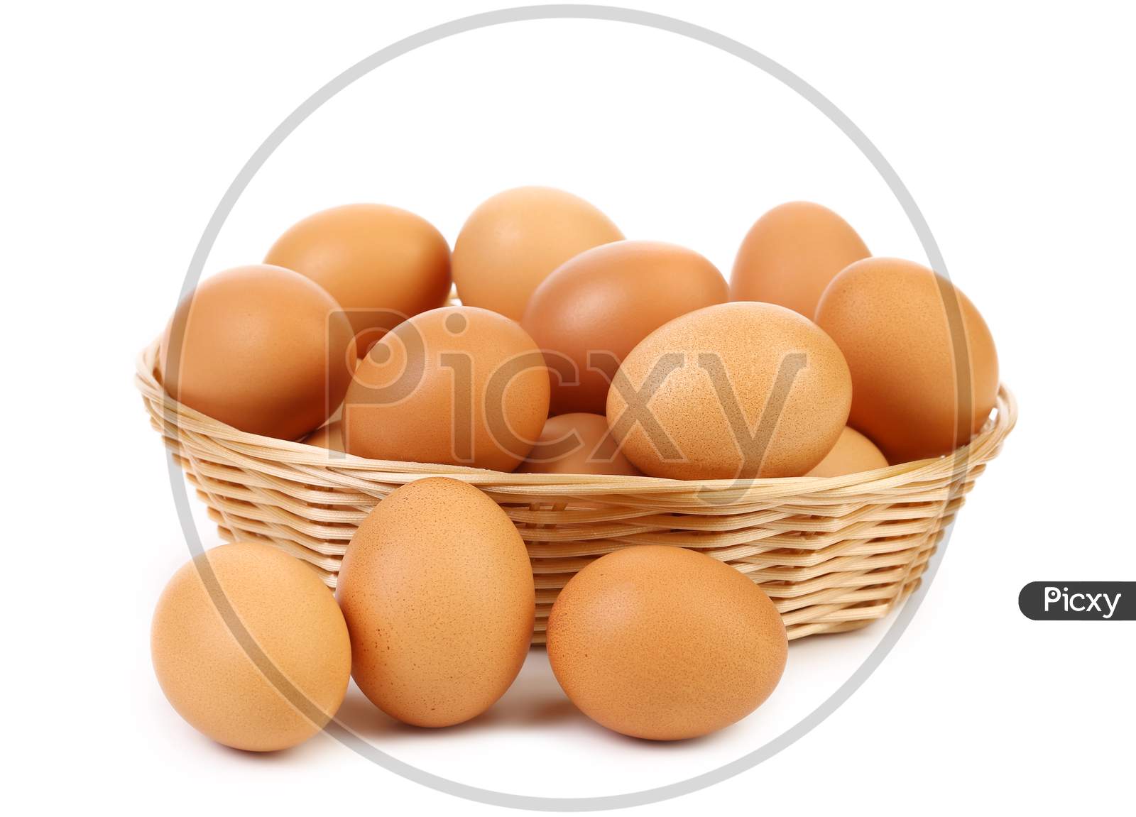 Brown Eggs In The Basket. Isolated On A White Background