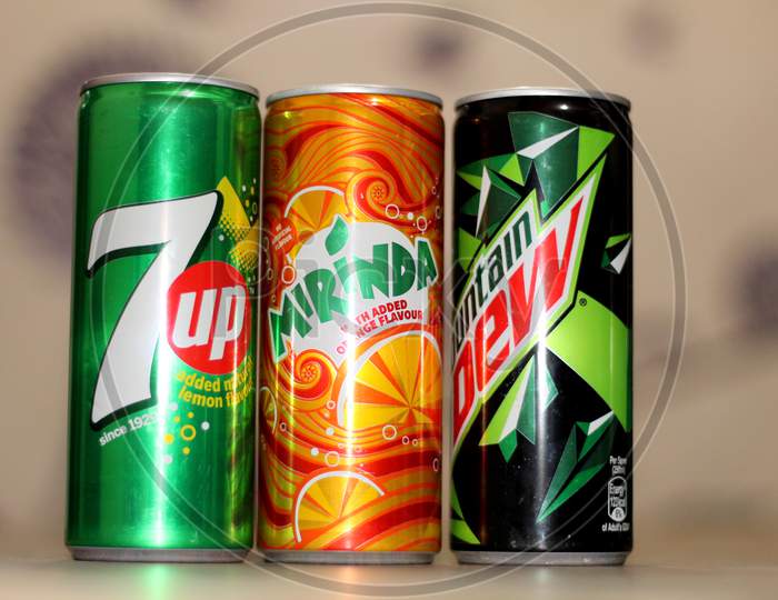 three soft drink cans
