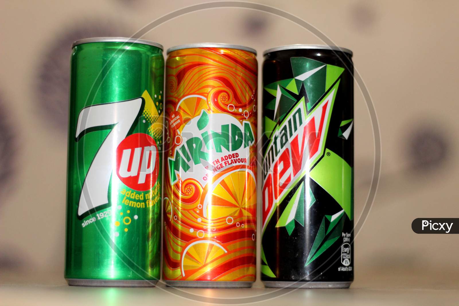 three soft drink cans