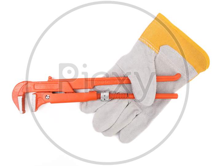 Wrench In White And Yellow Glove. Isolated On A White Background