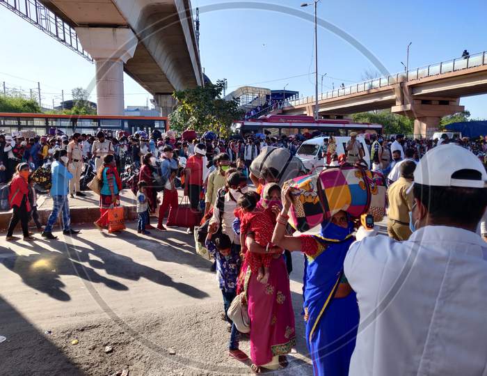 Thousands Of Migrants Lineup Outside the Anand Vihar Bus Terminal Hoping To Catch a Bus Home Amidst National Lockdown Due To COVID-19 Outbreak in India 
