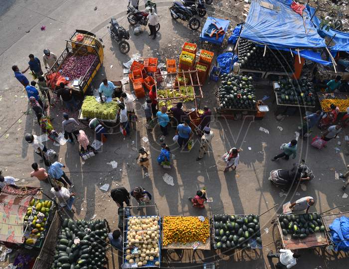 People fail to maintain social distance as they buy groceries, vegetables and fruits in a makeshif market under Kphb-Madhapur Flyover