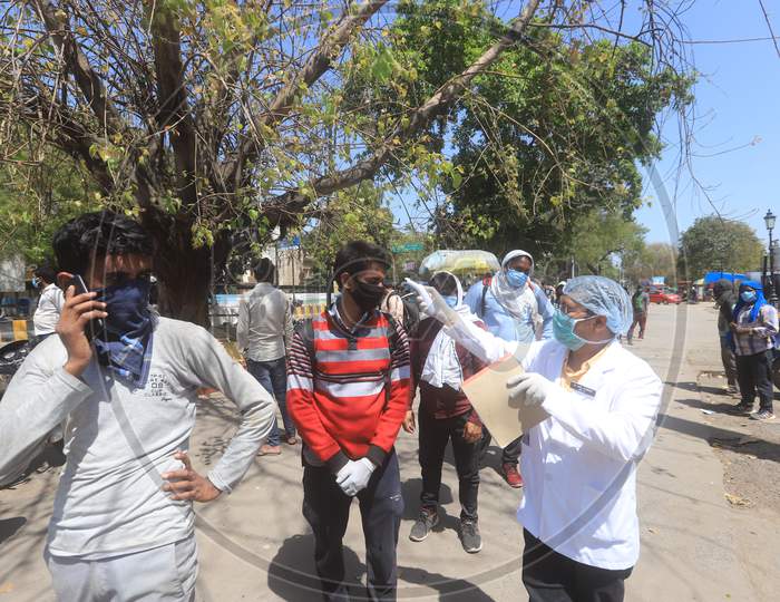 Doctors Examining  Migrant Workers With Thermal Scanners  , Who Are  Returning To Their Villages To Limit The Spread The Corona Virus Disease ( COVID-19) in Prayagraj. March 29 , 2020