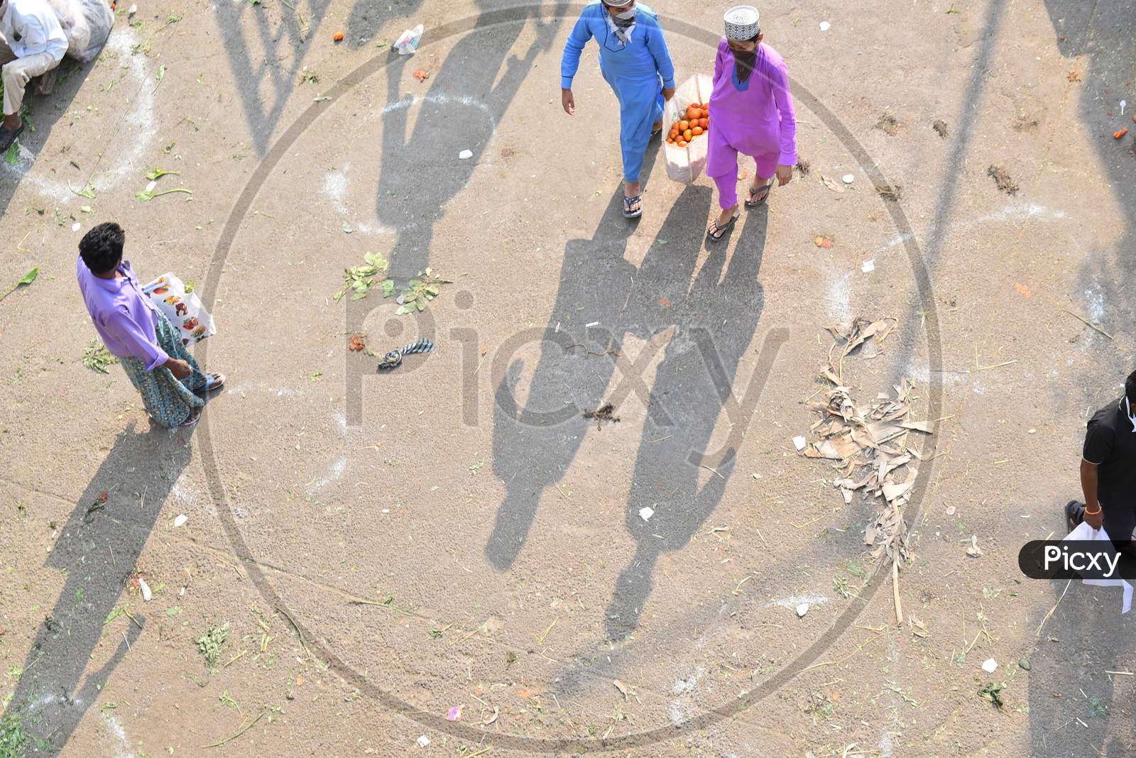 People buy vegetables at a makeshift market at Hitech city MMTS station amid corona virus pandemic in Hyderabad