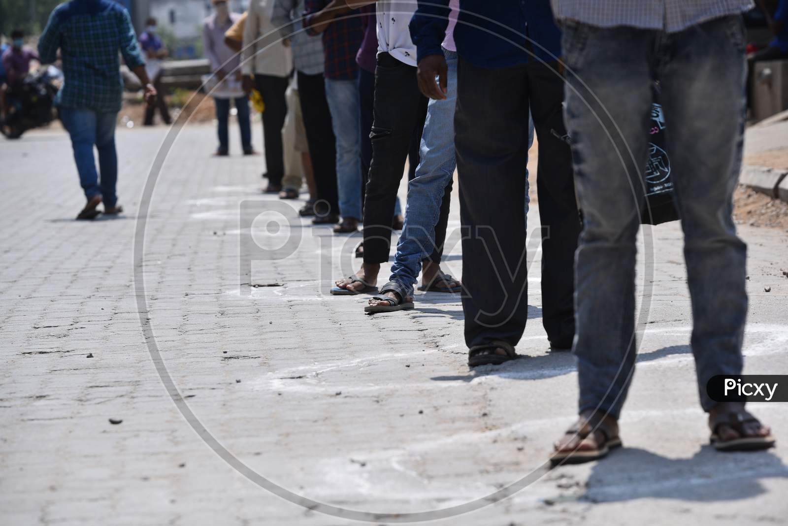 People maintain social distancing by standing in the circles drawn at a super market in Moosapet Y Junction, Hyderabad amid lockdown due to Corona Virus pandemic