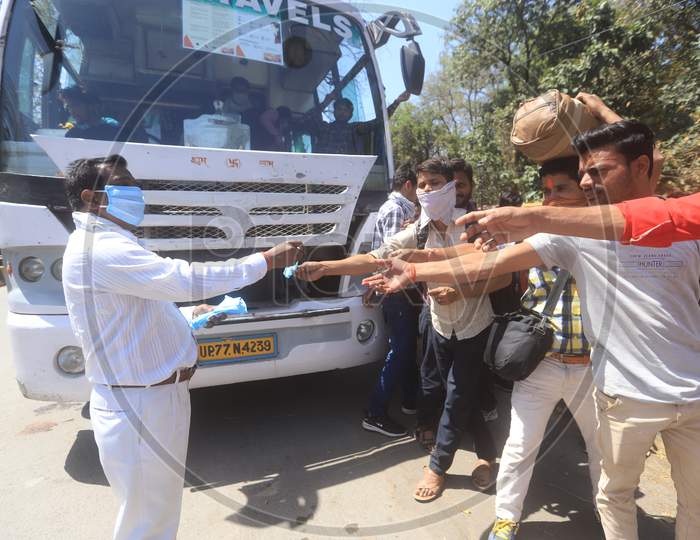 Authorities Distributing Masks For Migrant Workers, Who Are  Returning To Their Villages To Limit The Spread The Corona Virus Disease ( COVID-19) in Prayagraj. March 29 , 2020