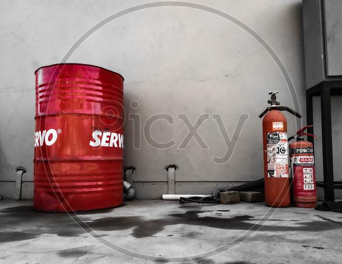 Contrasting objects. Servo Oil and Fire Extinguisher. 