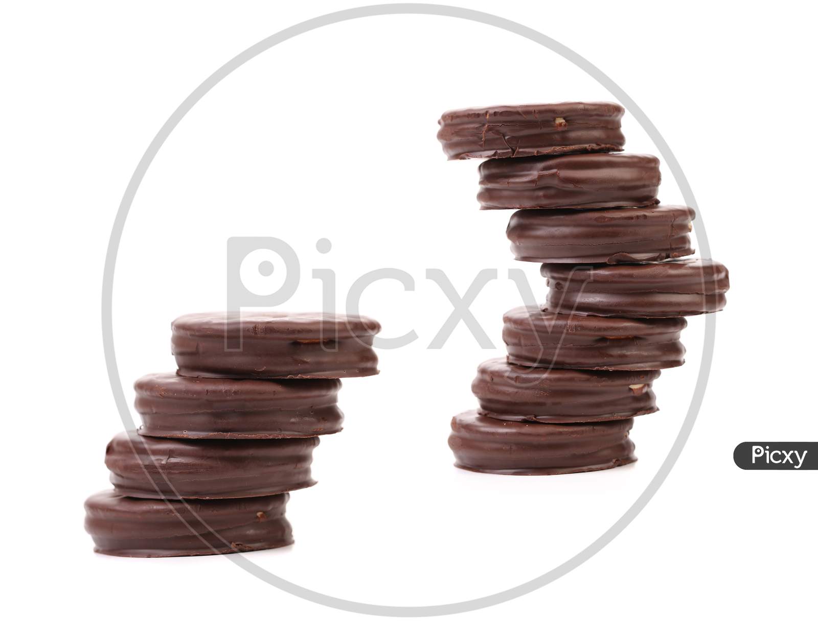 Two Stacks Of Round Chocolate Biscuit. Isolated On A White Background.