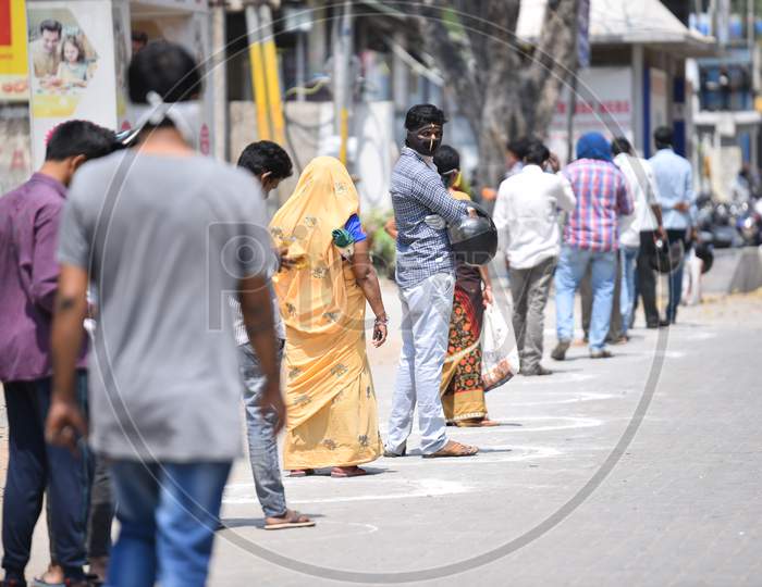 People maintain social distancing by standing in the circles drawn at a super market in Moosapet Y Junction, Hyderabad amid lockdown due to Corona Virus pandemic