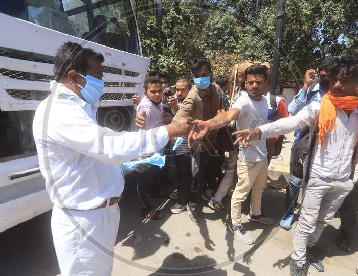 Authorities Distributing Masks For Migrant Workers, Who Are  Returning To Their Villages To Limit The Spread The Corona Virus Disease ( COVID-19) in Prayagraj. March 29 , 2020