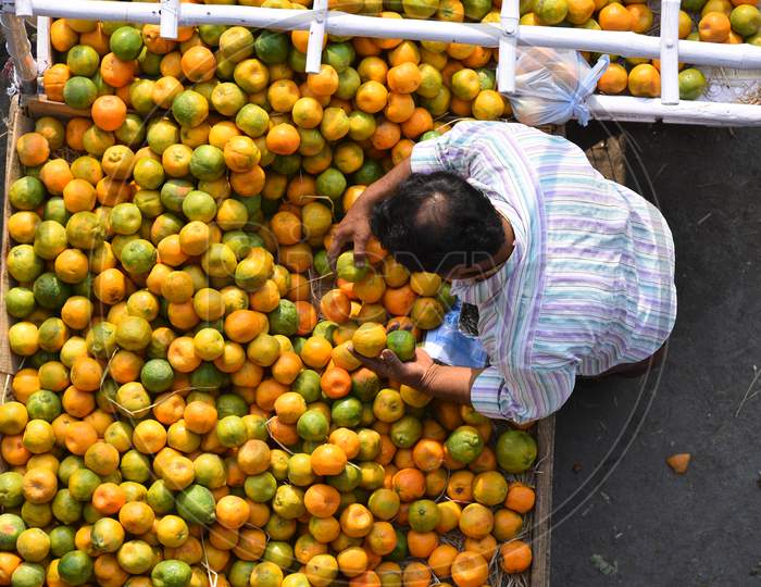 A orange fruit vendor arranges fruits, citric acid rich fruits gain demand amid corona virus outbreak
